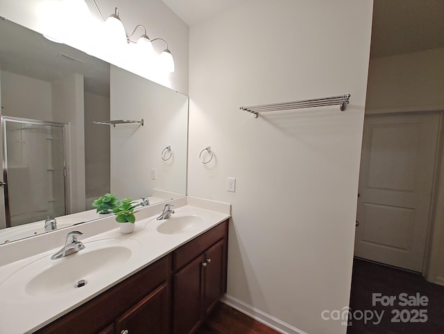 bathroom with vanity and a shower with door