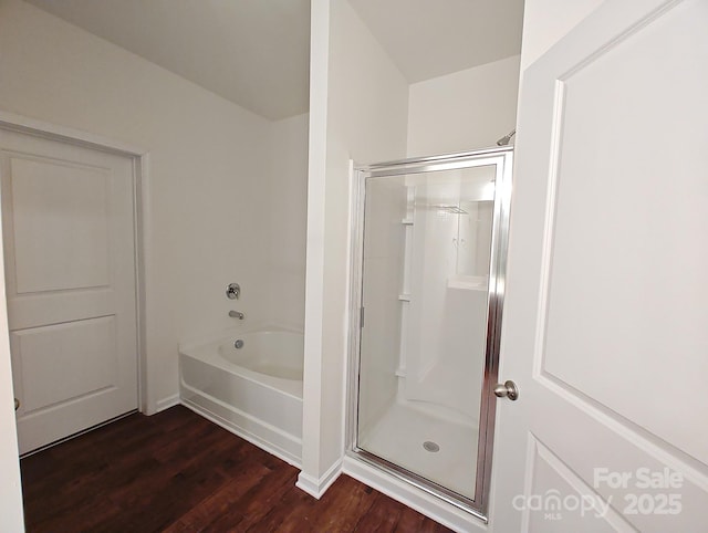 bathroom featuring hardwood / wood-style flooring and separate shower and tub