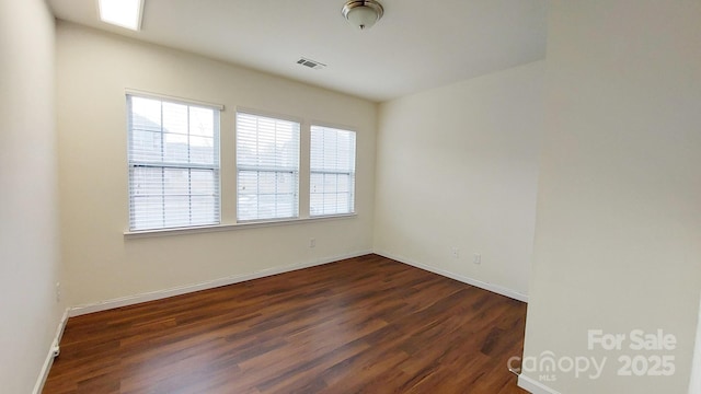 unfurnished room with dark wood-type flooring