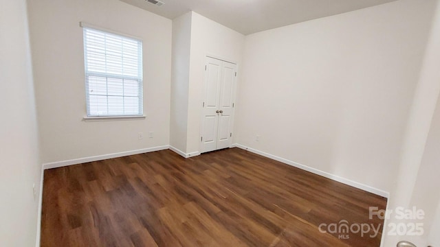 unfurnished room with dark hardwood / wood-style floors