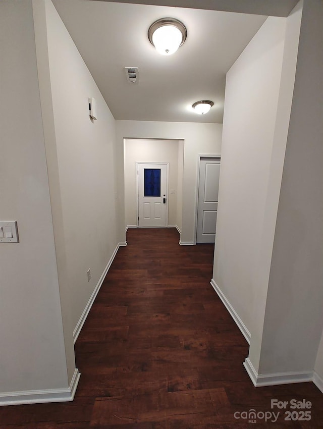 hallway with dark hardwood / wood-style floors