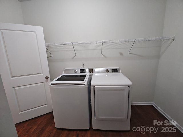 laundry area with dark hardwood / wood-style flooring and washing machine and dryer