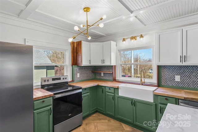 kitchen featuring wood counters, sink, white cabinetry, green cabinetry, and appliances with stainless steel finishes