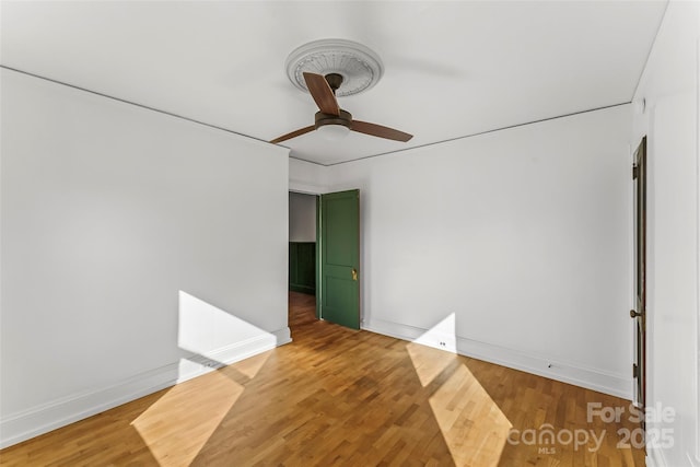 empty room with wood-type flooring and ceiling fan