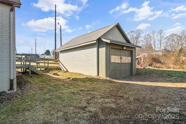 garage featuring a lawn