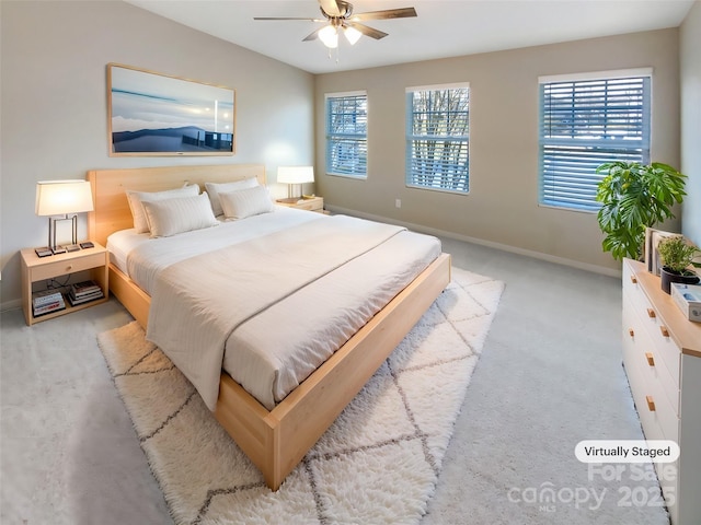 bedroom featuring ceiling fan and light carpet