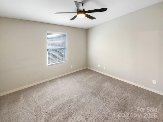 carpeted spare room featuring ceiling fan