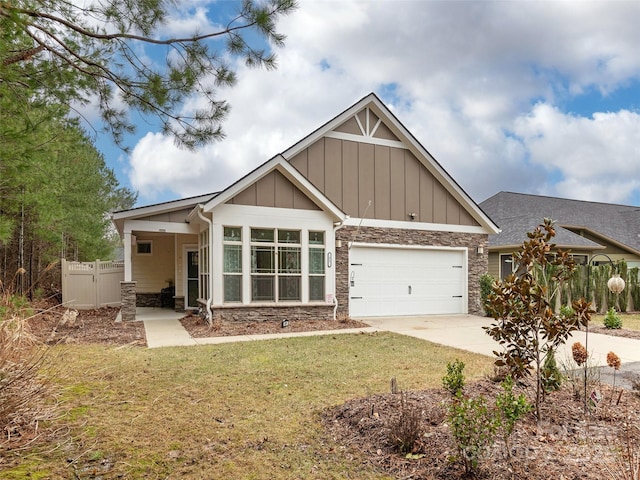 craftsman inspired home featuring a garage and a front yard