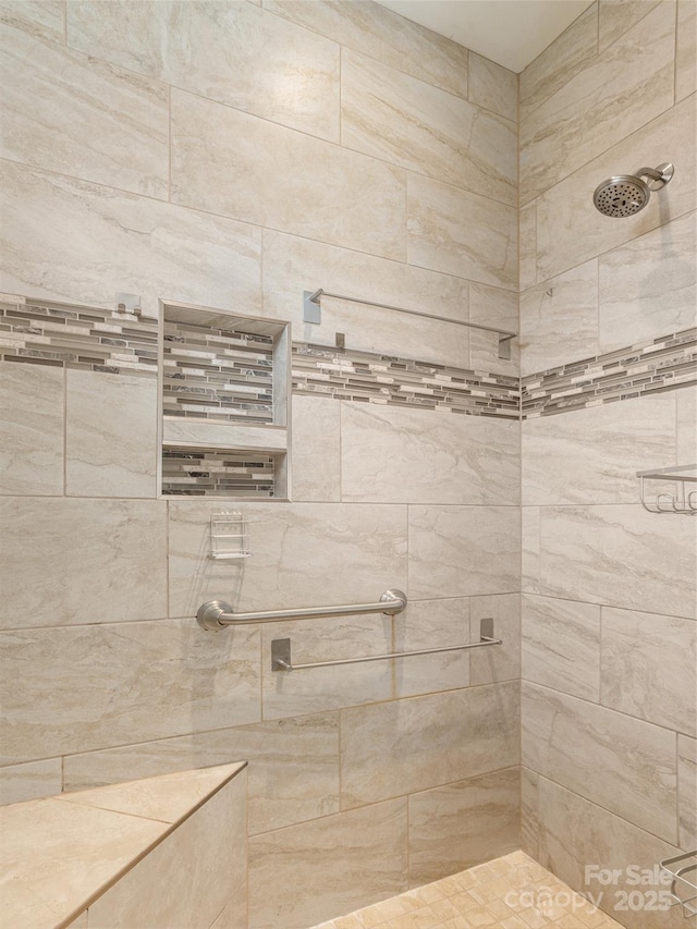 bathroom with a tile shower