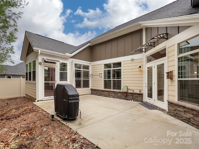 rear view of property with french doors and a patio area