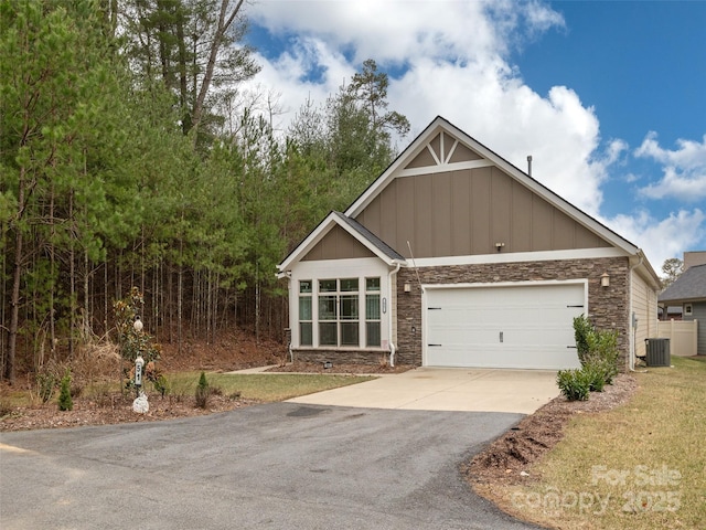 view of front of home featuring a garage and central AC