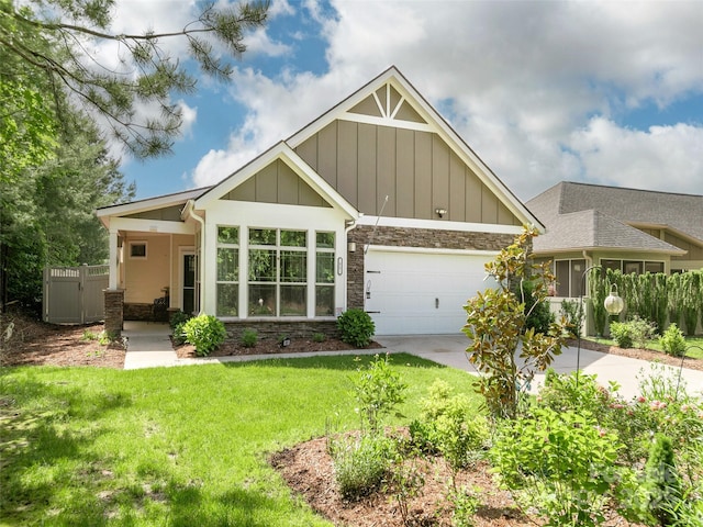 51 Honeycrisp Ct, Flat Rock, NC 28731 - craftsman-style home with stone siding, board and batten siding, concrete driveway, a front yard, and a garage