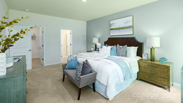 bedroom with carpet flooring and a spacious closet