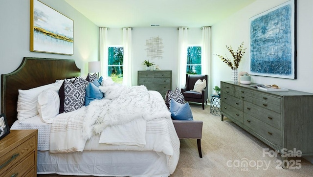 bedroom featuring light colored carpet