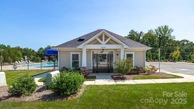 view of front of house with a fenced in pool