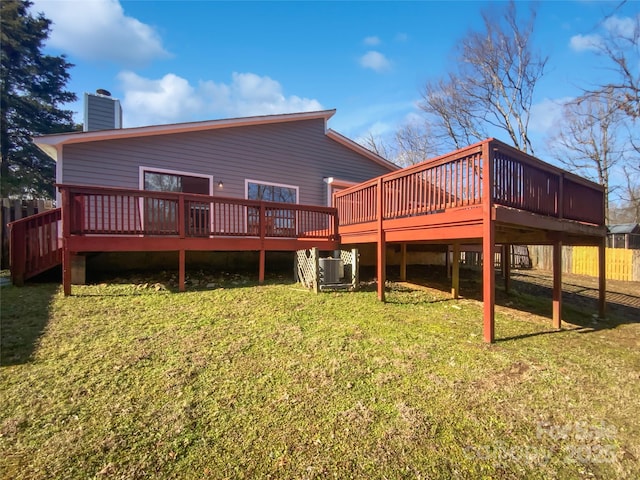 rear view of house with central AC unit, a yard, and a deck