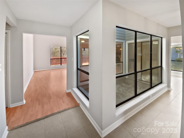 corridor with light tile patterned flooring