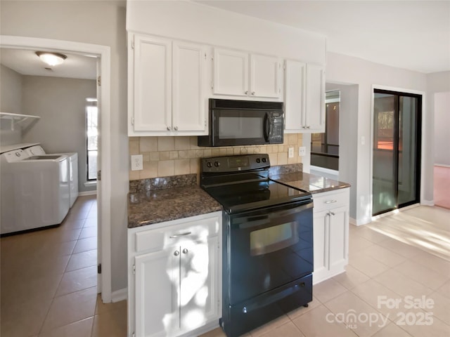 kitchen with washing machine and dryer, tasteful backsplash, black appliances, white cabinets, and light tile patterned flooring