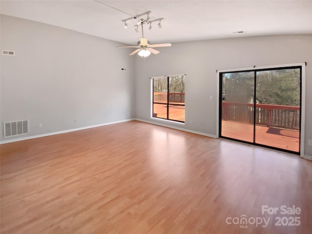 empty room with ceiling fan and light hardwood / wood-style floors