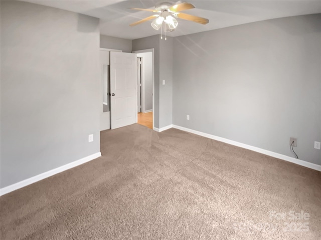 carpeted spare room with ceiling fan