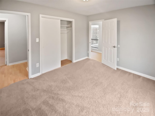 unfurnished bedroom with carpet flooring and a closet