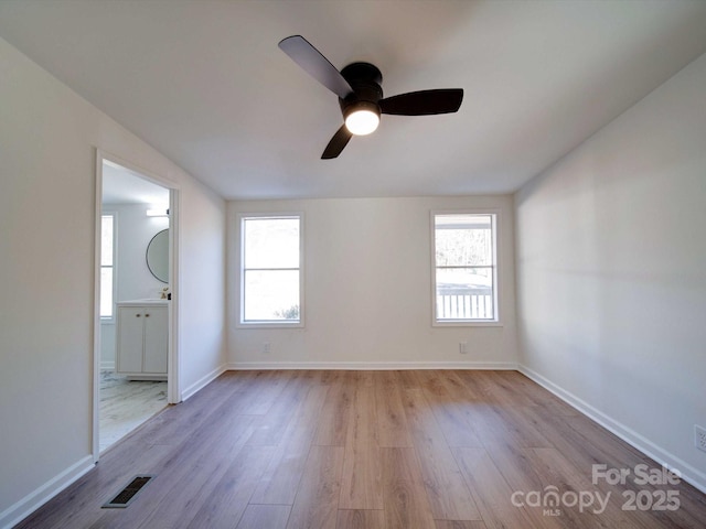 spare room featuring plenty of natural light and light wood-type flooring