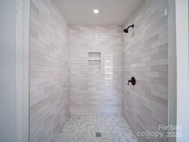 bathroom with tiled shower