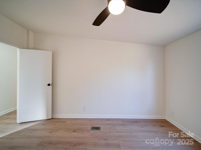 spare room featuring ceiling fan and light hardwood / wood-style flooring