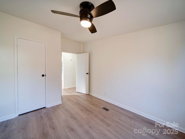 unfurnished bedroom with ceiling fan and light hardwood / wood-style floors