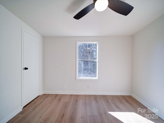 empty room featuring ceiling fan and light hardwood / wood-style flooring