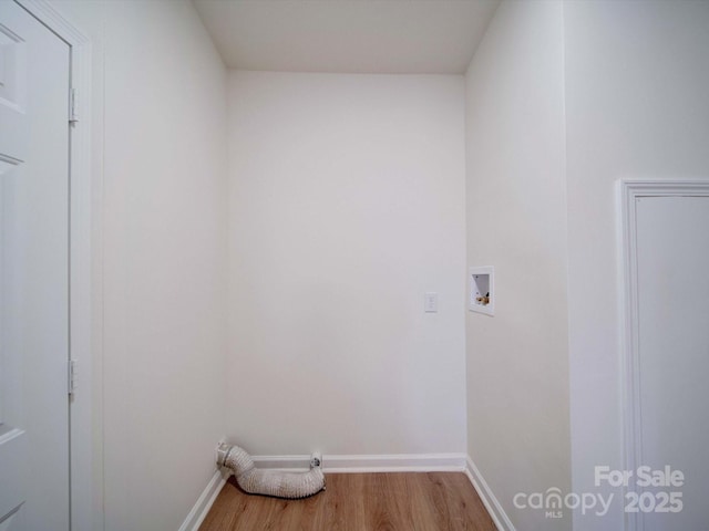 laundry room with washer hookup and hardwood / wood-style floors