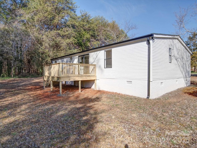 back of house featuring a wooden deck