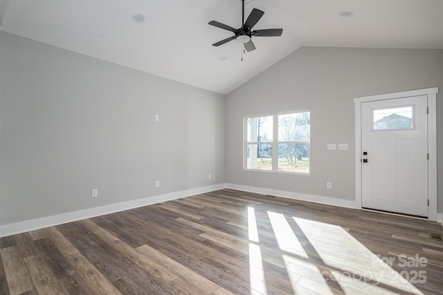 entryway with vaulted ceiling, a healthy amount of sunlight, and dark hardwood / wood-style floors