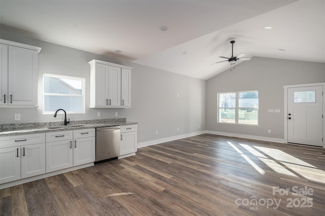 kitchen with dark hardwood / wood-style floors, white cabinetry, sink, stainless steel dishwasher, and light stone countertops