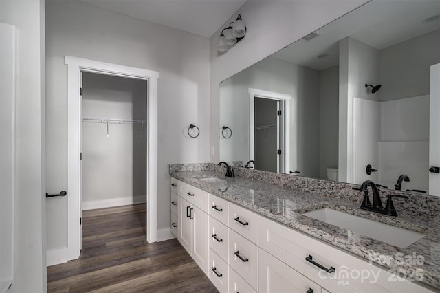 bathroom with vanity, toilet, and hardwood / wood-style floors