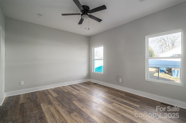 spare room featuring ceiling fan and dark hardwood / wood-style flooring