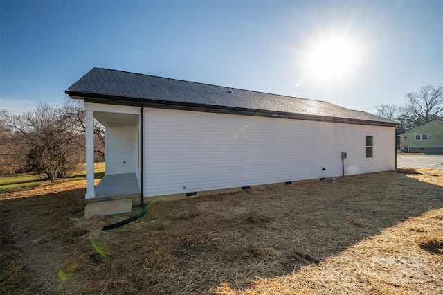 view of side of home featuring a lawn