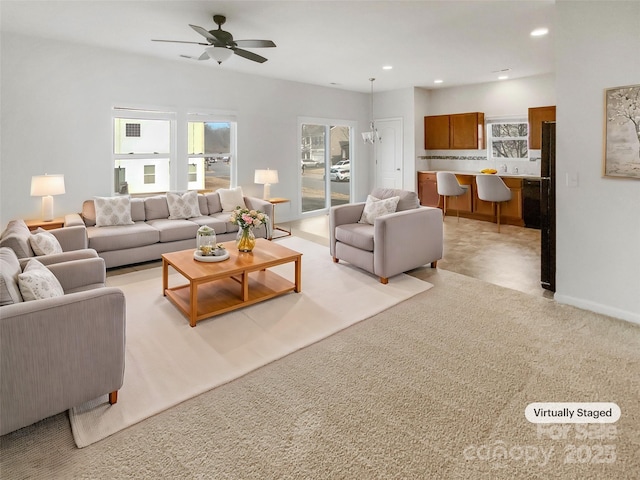 carpeted living room featuring ceiling fan