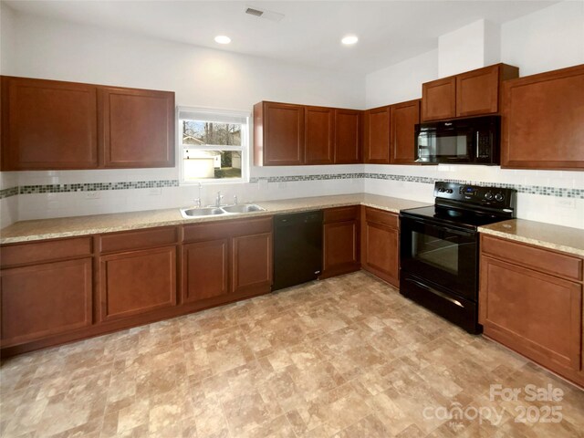 kitchen featuring tasteful backsplash, sink, and black appliances