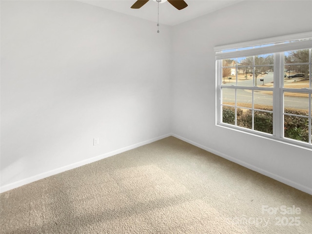 carpeted spare room featuring ceiling fan