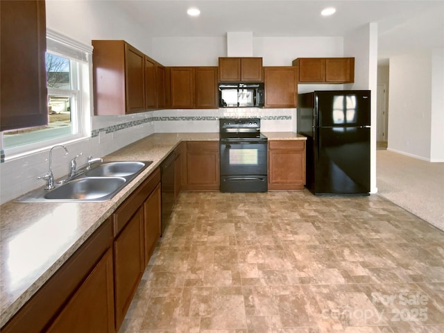 kitchen with sink, backsplash, and black appliances