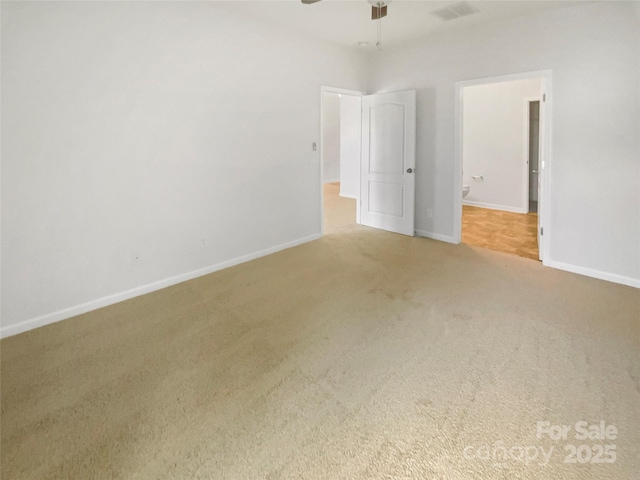 spare room featuring carpet and ceiling fan