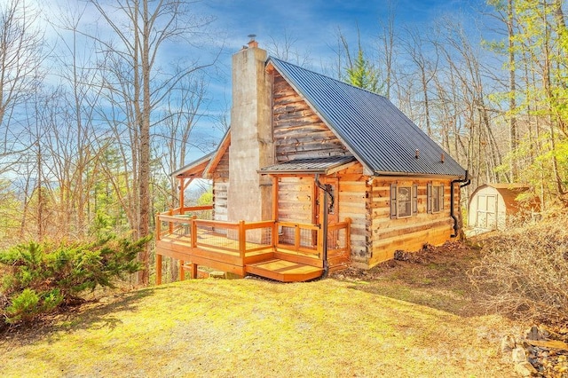 view of outbuilding featuring a lawn