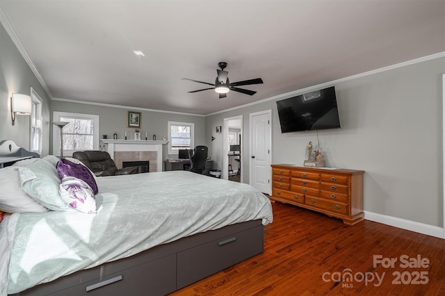 bedroom with ceiling fan, a fireplace, ornamental molding, and dark hardwood / wood-style flooring