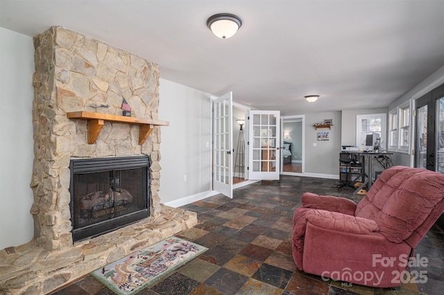 living room with a fireplace and french doors