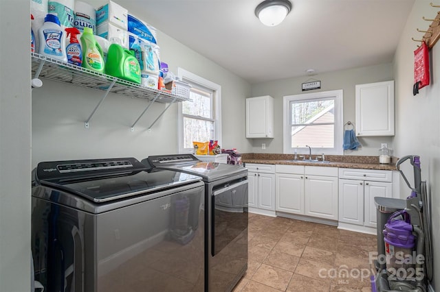 washroom featuring cabinets, independent washer and dryer, sink, and light tile patterned floors