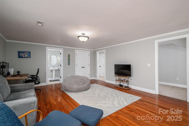 living room with wood-type flooring and ornamental molding