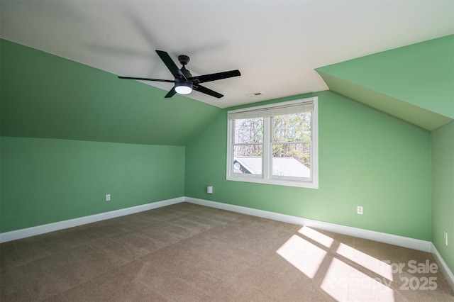 additional living space featuring lofted ceiling, carpet floors, and ceiling fan