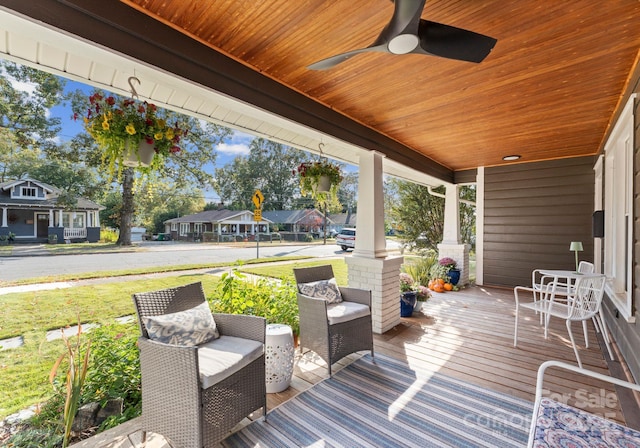 deck with a residential view, covered porch, and ceiling fan