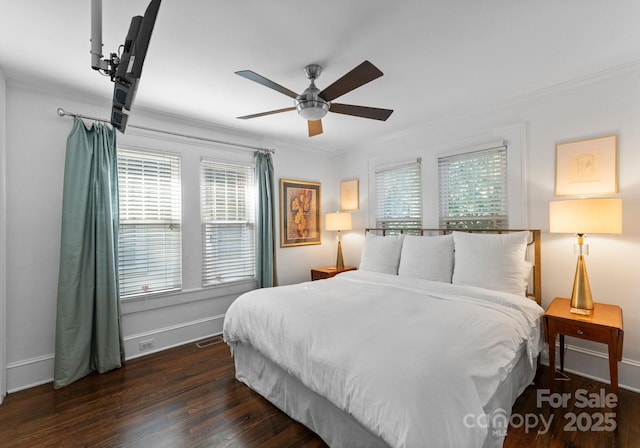 bedroom featuring ornamental molding, dark wood finished floors, and baseboards